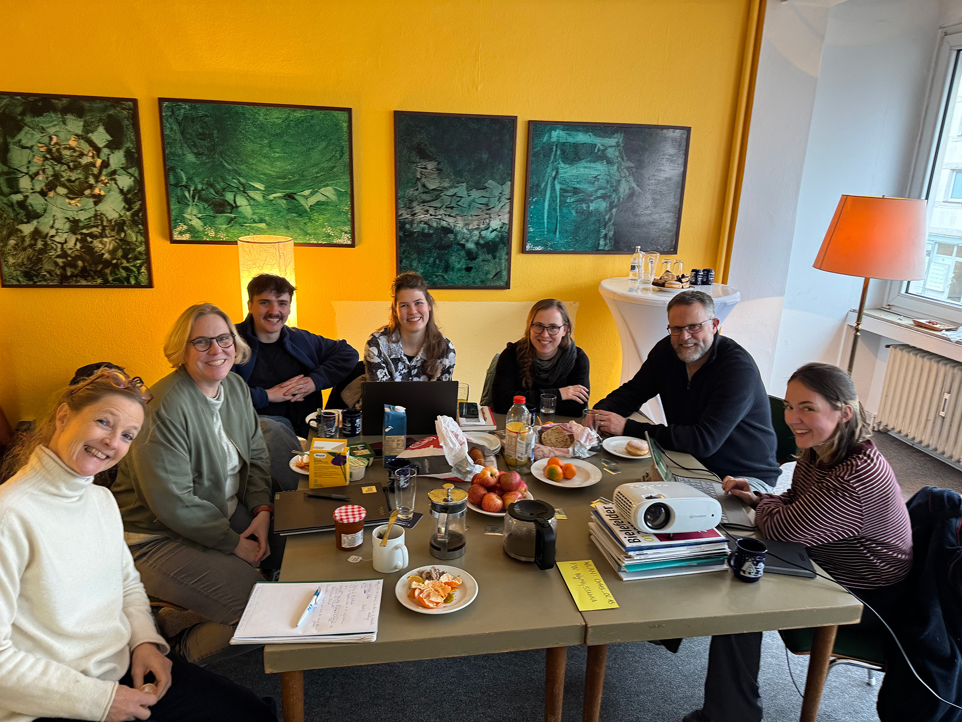 Das Kernteam des Netzwerks sitzt zusammen einem Tisch und planen etwas